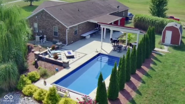 outdoor pool featuring a patio area, a lawn, and cooling unit