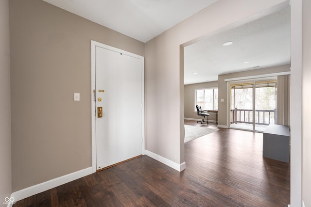 entrance foyer featuring dark wood-style floors and baseboards