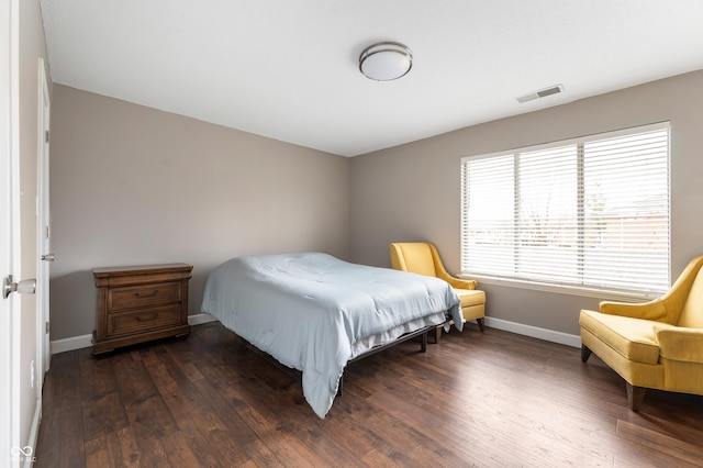 bedroom featuring visible vents, baseboards, and dark wood-style floors