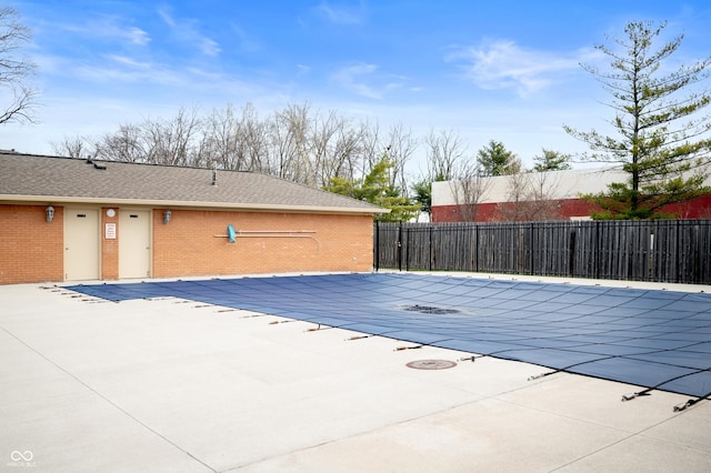 view of swimming pool featuring a fenced in pool, a patio, and fence