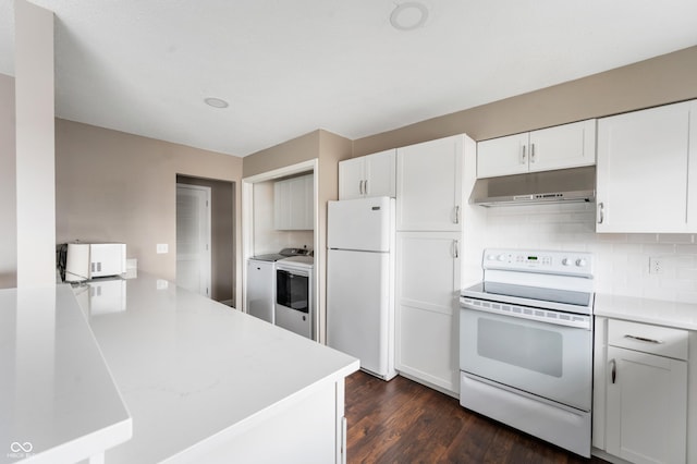 kitchen featuring under cabinet range hood, decorative backsplash, white appliances, and light countertops