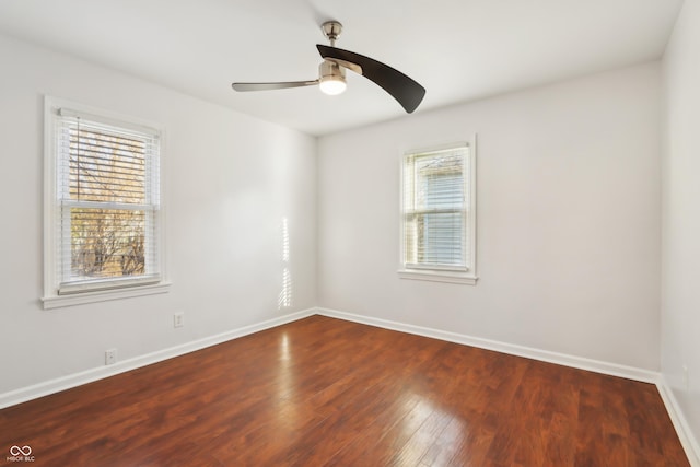 unfurnished room featuring a ceiling fan, baseboards, and wood-type flooring