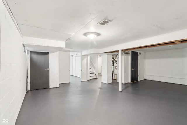 finished basement with visible vents and stairway