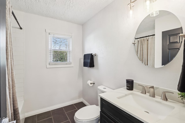 bathroom with toilet, a textured ceiling, tile patterned flooring, baseboards, and vanity