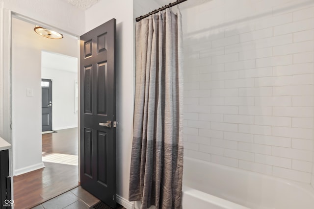 bathroom with tile patterned flooring, vanity, and shower / bathtub combination with curtain