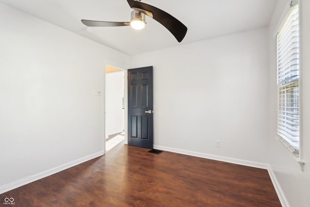 unfurnished room featuring baseboards, ceiling fan, and wood finished floors