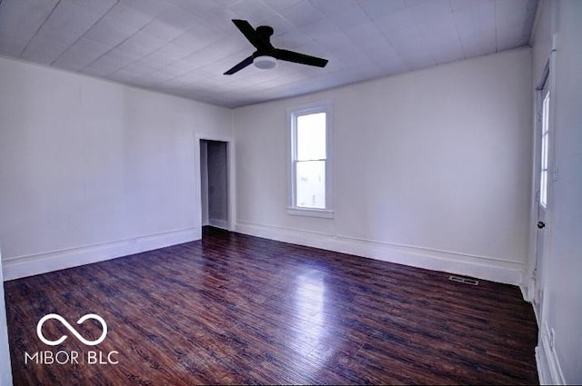 unfurnished room with wood finished floors, baseboards, and ceiling fan