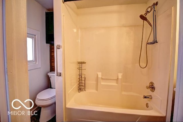 bathroom featuring toilet and shower / bath combination