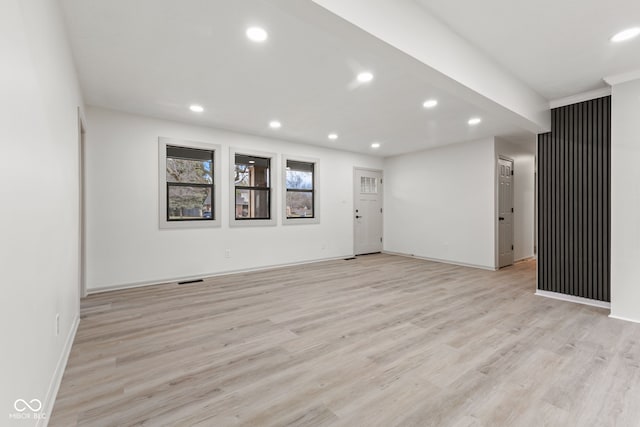 unfurnished room with recessed lighting, light wood-type flooring, and baseboards