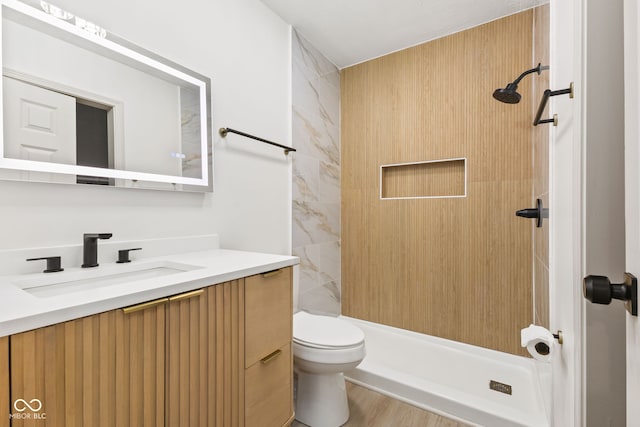 full bath featuring a shower stall, vanity, and toilet