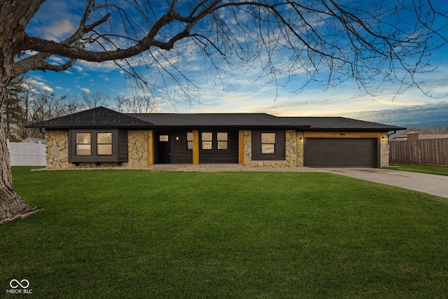 view of front of property with a garage, stone siding, a front lawn, and fence