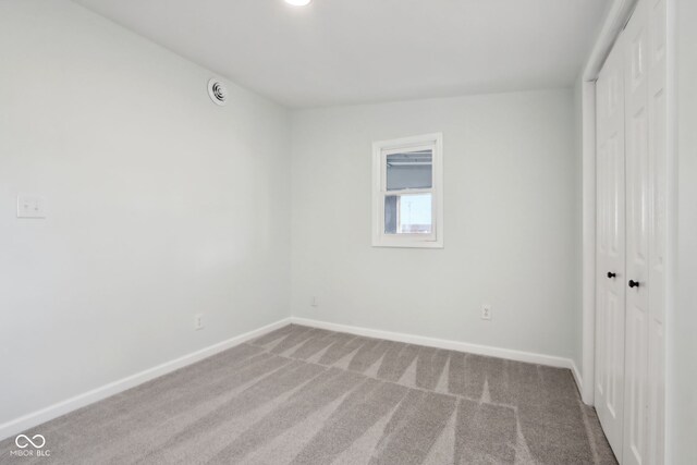 unfurnished bedroom with baseboards, a closet, and carpet floors