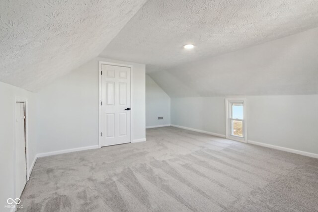 bonus room featuring carpet floors, baseboards, and vaulted ceiling