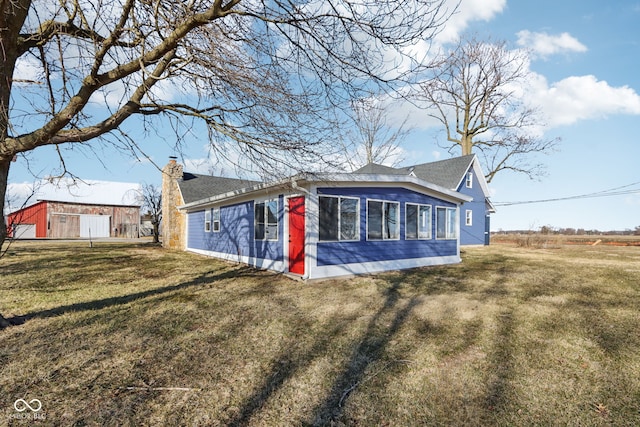 exterior space featuring a lawn and a chimney