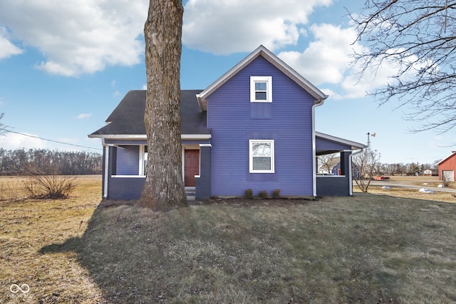 rear view of house featuring a yard