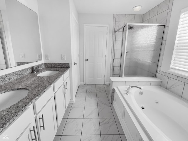 bathroom with marble finish floor, a stall shower, a healthy amount of sunlight, and a sink