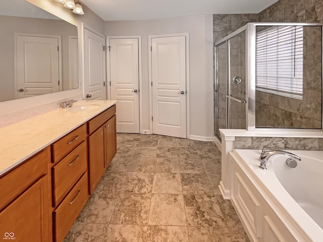 full bathroom featuring baseboards, a stall shower, vanity, and a garden tub