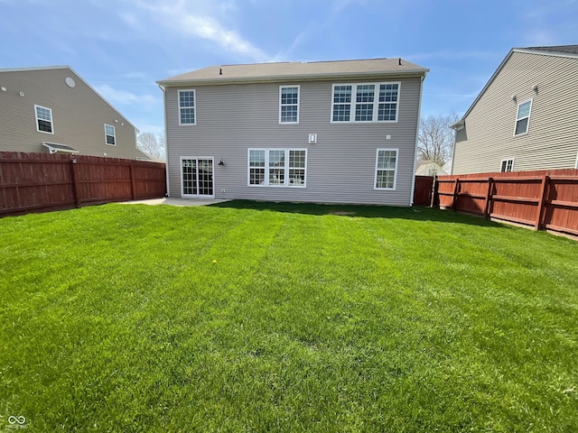 rear view of property with a patio area, a lawn, and a fenced backyard