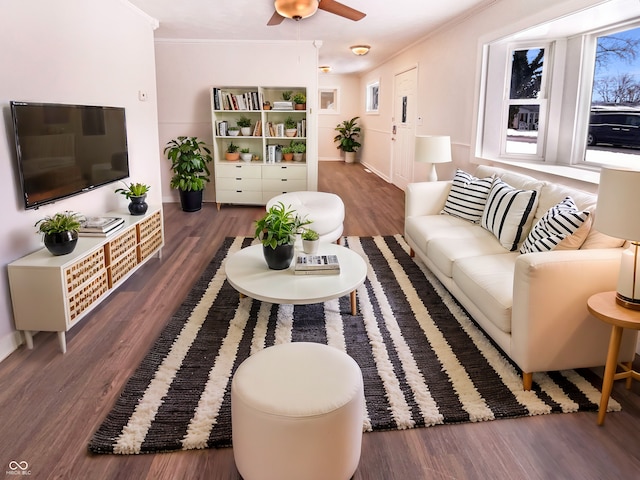 living room with a ceiling fan, crown molding, wood finished floors, and a healthy amount of sunlight