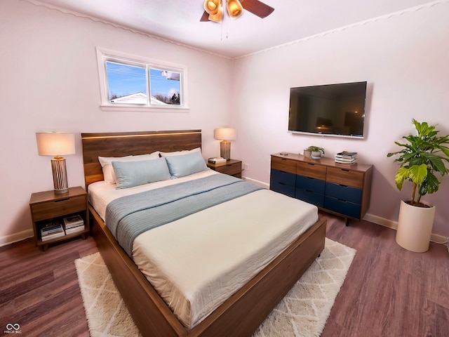 bedroom featuring a ceiling fan, baseboards, and wood finished floors