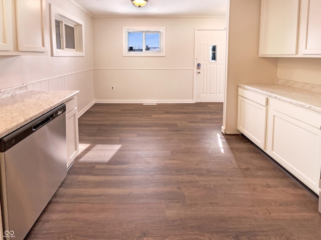 unfurnished dining area featuring wainscoting, dark wood-type flooring, and ornamental molding