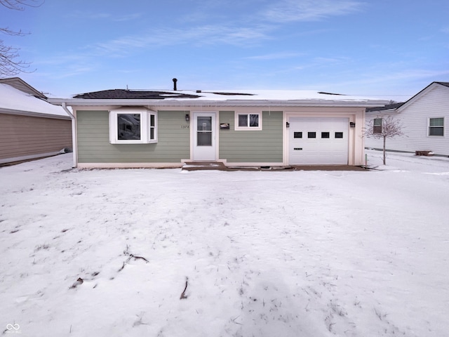 view of front of home featuring roof mounted solar panels and a garage