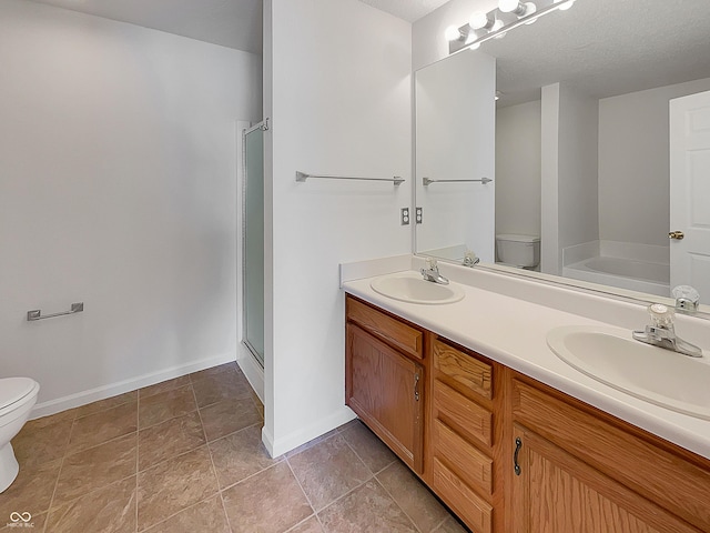 full bath with double vanity, toilet, a shower stall, and a sink