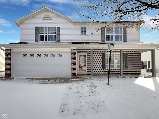 traditional home with an attached garage, covered porch, and brick siding