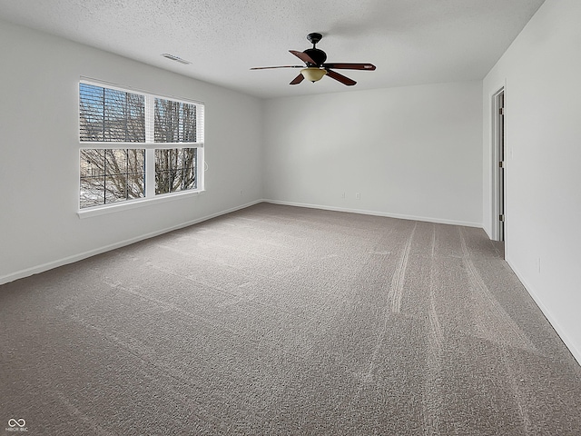 unfurnished room with baseboards, visible vents, carpet floors, and a textured ceiling