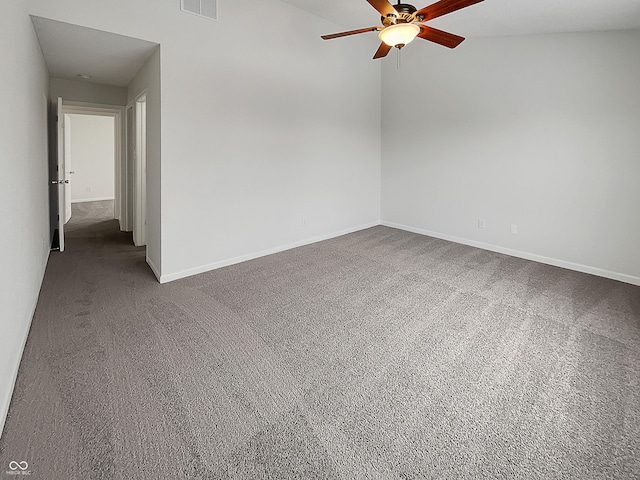 carpeted spare room featuring visible vents, a ceiling fan, and baseboards