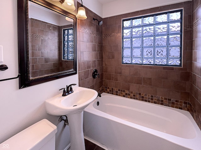 bathroom featuring toilet and  shower combination