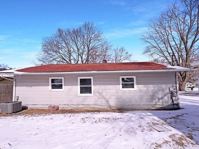 view of snow covered exterior with central AC unit