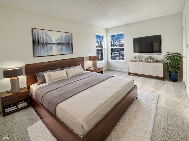 bedroom featuring baseboards, carpet floors, and a textured ceiling