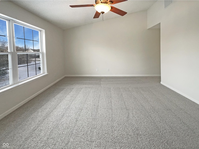 spare room featuring visible vents, baseboards, carpet, a textured ceiling, and a ceiling fan