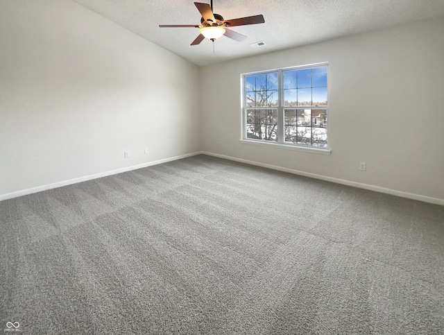 carpeted spare room with baseboards, a textured ceiling, and ceiling fan