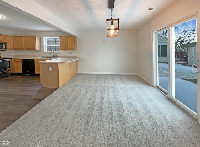 kitchen featuring baseboards, light countertops, a peninsula, stainless steel appliances, and a textured ceiling