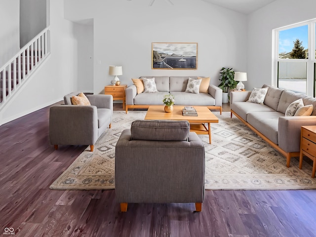 living area featuring stairway and wood finished floors