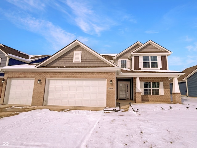 view of front of home featuring brick siding, covered porch, and an attached garage