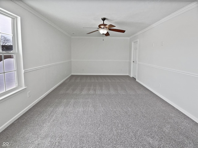 empty room with ceiling fan, baseboards, carpet, and ornamental molding