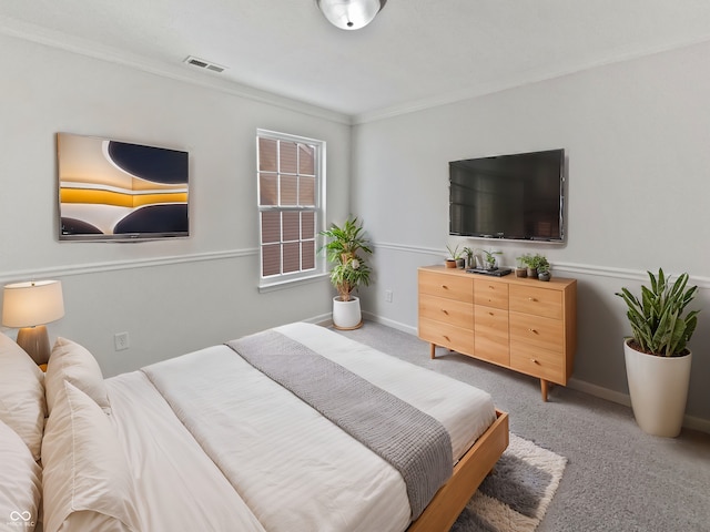 bedroom with visible vents, light carpet, baseboards, and ornamental molding