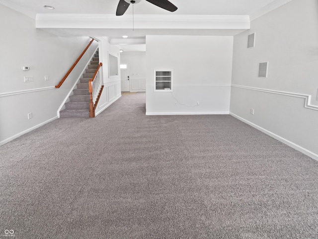 unfurnished living room featuring baseboards, carpet, ornamental molding, and stairs