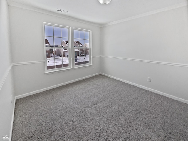 carpeted empty room featuring visible vents, baseboards, and crown molding