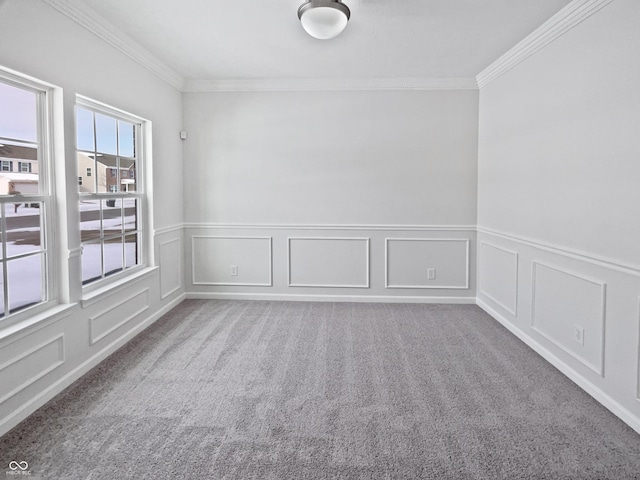 carpeted empty room with a decorative wall and ornamental molding