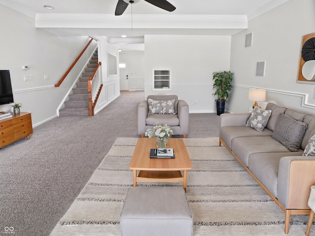 living area featuring ornamental molding, stairway, carpet flooring, baseboards, and ceiling fan