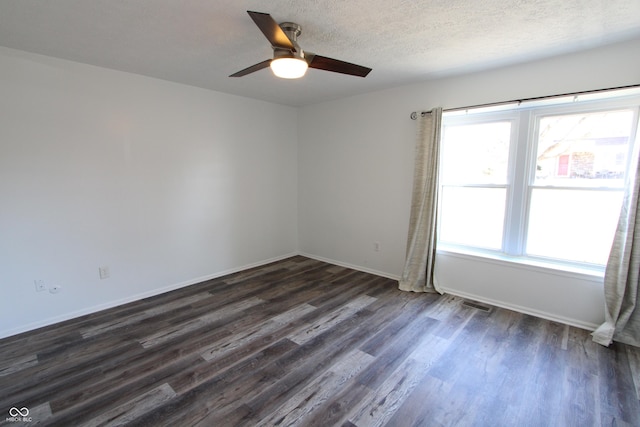 unfurnished room with visible vents, dark wood-type flooring, a textured ceiling, baseboards, and ceiling fan