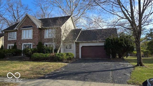 view of front facade featuring aphalt driveway, brick siding, a garage, and a front yard