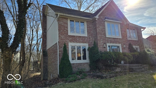 view of home's exterior with brick siding