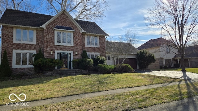 view of front of home featuring brick siding, driveway, and an attached garage