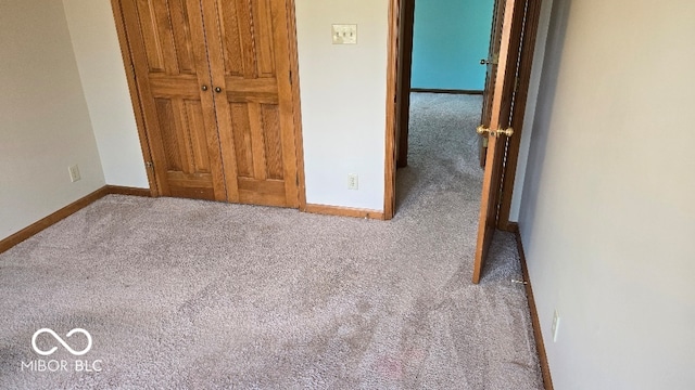 unfurnished bedroom with baseboards and carpet floors