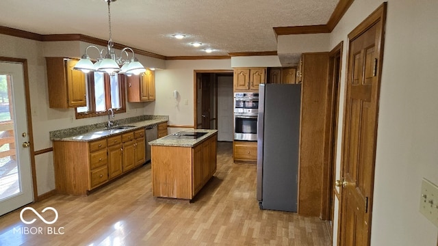 kitchen featuring light wood-type flooring, a sink, a center island, appliances with stainless steel finishes, and brown cabinetry